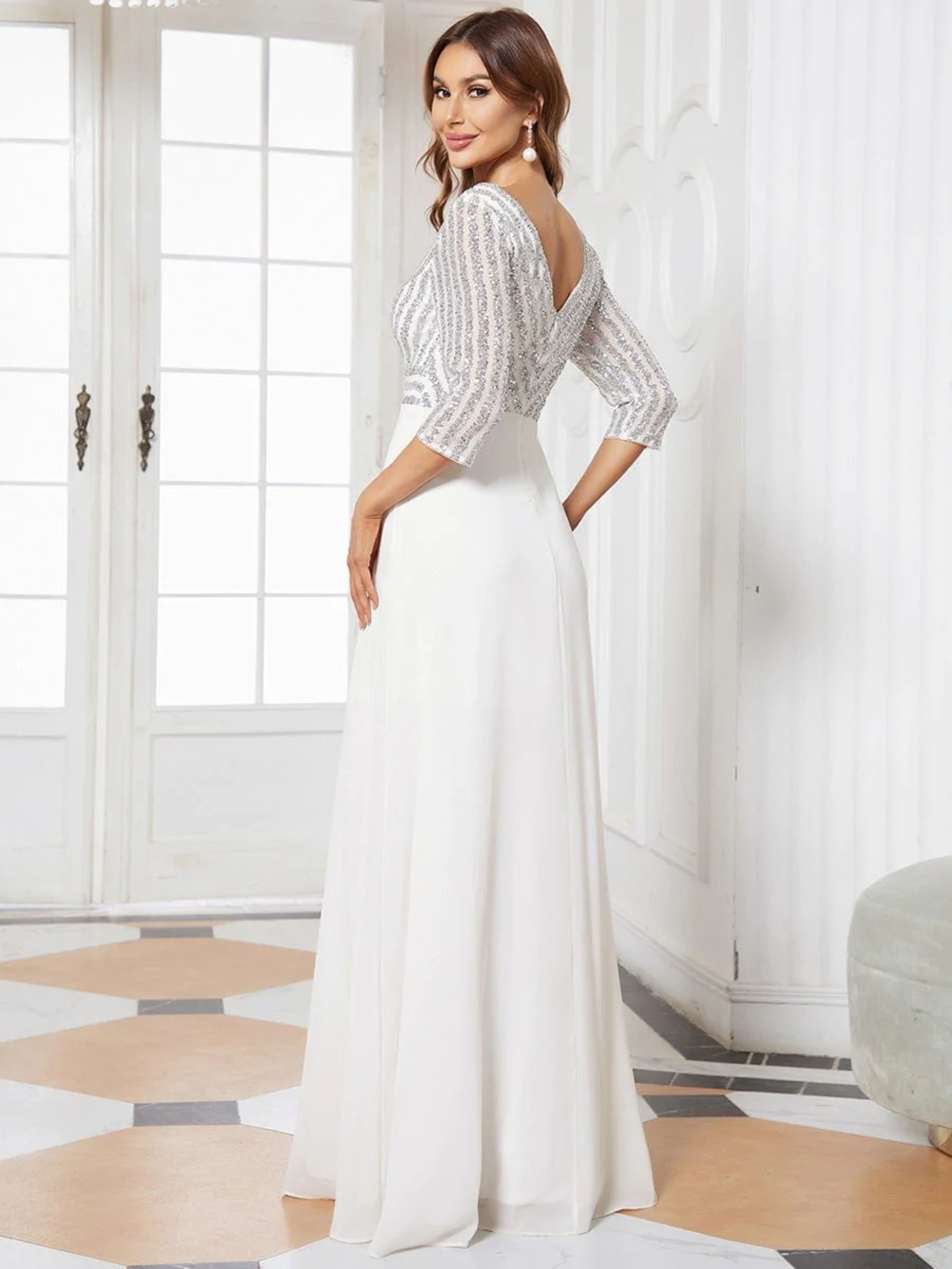 FEATURING A DOUBLE DEEP V NECKLINE, LONG SLEEVES AND A FLOWY A-LINE SKIRT.