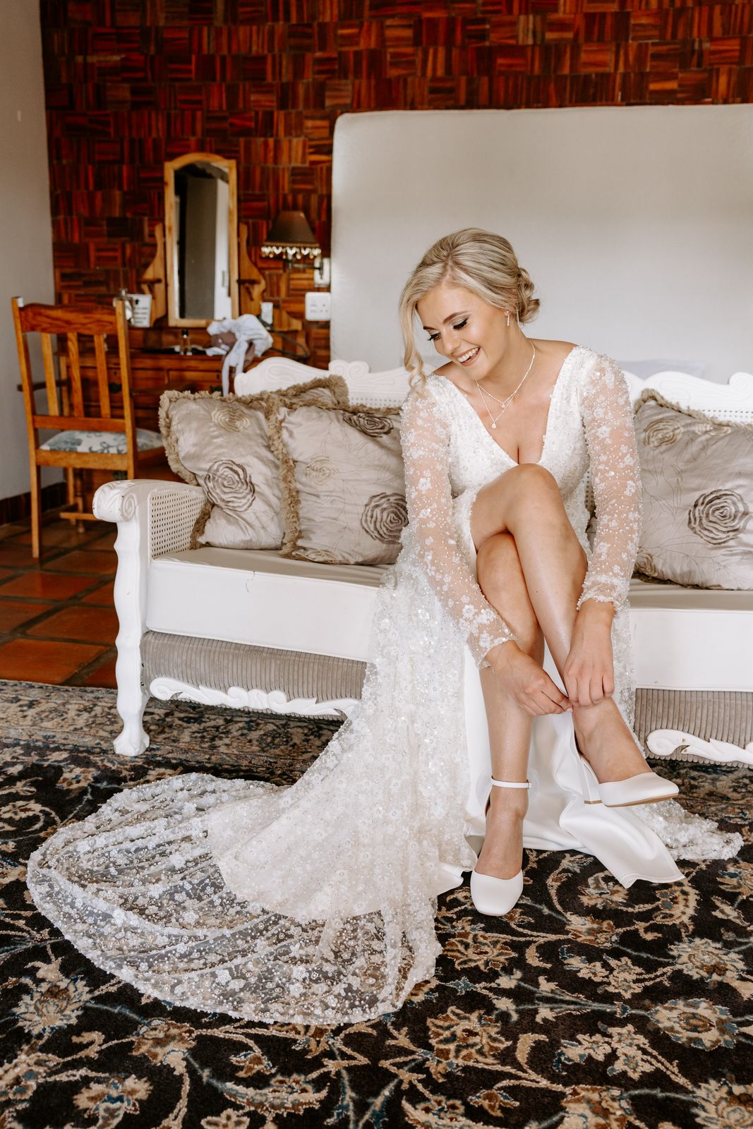 amy Glamorous Full Beaded Sequin Wrap Bridal Gown A showstopping design for the bride who loves all-out glamour and high-fashion elegance, this fully beaded sequin bridal gown is made to shine from every angle. ✨ Design Highlights: ✔ Long sleeves – Sheer and sophisticated, adding drama and grace. ✔ Wrap-over bodice – Flattering and secure, with a deep V effect for a modern silhouette. ✔ Fully beaded with shimmering sequins – Luxe detailing for a dazzling finish. ✔ Ruched skirt with thigh-high slit – A striking design element that adds movement and allure. ✔ Low open back – Sensual and refined, perfect for a dramatic statement. ✔ Button and zip closure – A classic finish with modern practicality. ✔ Long train – Flows behind you for a captivating bridal entrance. 💫 Customization Options: ✅ Tailored to your exact measurements for a perfect fit. ✅ Available in your preferred colour. ✅ Choose between a long or short train. ✅ Option for a lower slit or none depending on your preference. ✅ Personalize with sleeve length or neckline changes. 👑 A gown for the confident bride who isn’t afraid to dazzle. 👑 📞 Custom orders available! 📧 info@bestersbridal.co.za | 📱 084 268 1354