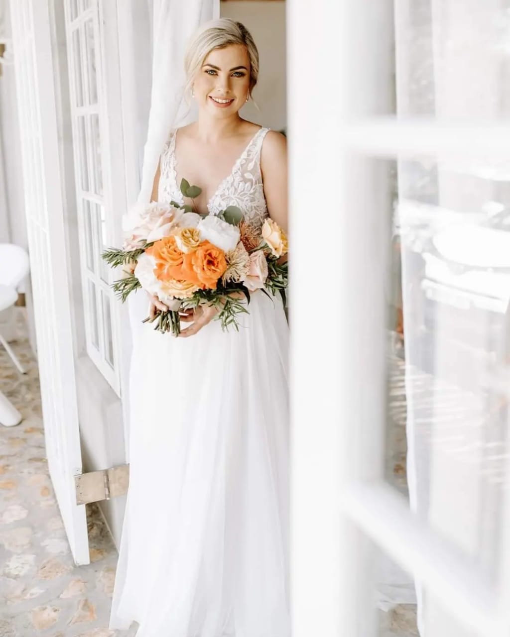 ninine Ethereal Tulle & 3D Leaf Lace A-Line Bridal Gown A breathtaking blend of romance and elegance, this tulle and lace wedding gown is designed for the bride who dreams of a soft, ethereal silhouette with intricate details. ✨ Design Highlights: ✔ Deep plunging bustline – A striking yet sophisticated feature that enhances the bodice. ✔ 3D leaf lace appliqués – Exquisitely placed for a nature-inspired, whimsical touch. ✔ Illusion tulle and lace button-back closure – A delicate and enchanting detail. ✔ Full-flare A-line tulle skirt – Light, airy, and flowing for a dreamy, princess-like effect. 💫 Customization Options: ✅ Made to measure for the perfect fit. ✅ Available in your preferred colour. ✅ Choose a long or short train to match your vision. ✅ Option for short or long sleeves for added versatility. ✅ Personalize it with or without a slit for a modern or classic touch. 👑 A gown for the bride who desires timeless beauty with a touch of nature-inspired romance. 👑 📞 Custom orders available! 📧 info@bestersbridal.co.za | 📱 084 268 1354