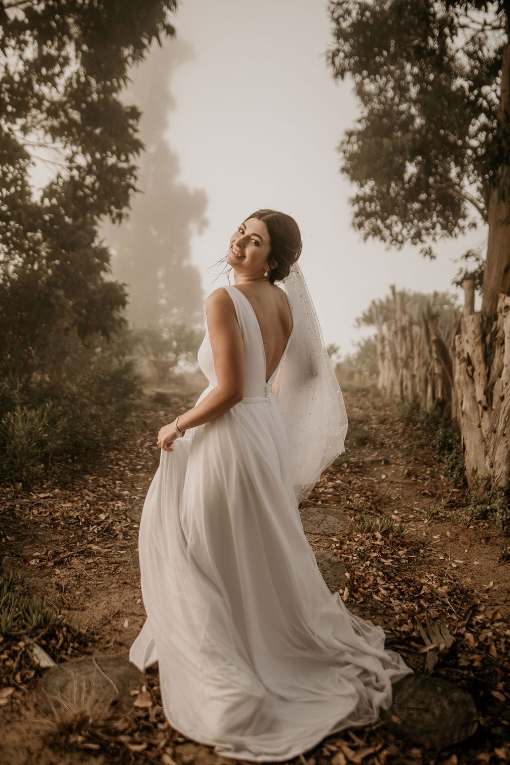 angelique Two-in-One Elegance – Crepe & Tulle A-Line Bridal Gown This breathtaking two-in-one bridal gown blends sleek sophistication with dreamy romance, perfect for the bride who desires both structure and softness on her special day. ✨ Design Highlights: ✔ Deep V-neckline – A bold yet elegant cut that enhances the décolletage. ✔ Low V-back bodice – A striking detail for a modern, sophisticated touch. ✔ Flowing A-line crepe dress – A smooth and flattering silhouette. ✔ Soft full-flare tulle overlay skirt – Adds volume and ethereal beauty. ✔ Short train on the crepe gown & long train on the tulle overskirt – Creating a stunning contrast and versatility. 💫 Customization Options: ✅ Tailored to your exact measurements for a flawless fit. ✅ Available in your choice of colour. ✅ Choose between a long or short train to match your vision. ✅ Option for short or long sleeves for added versatility. ✅ Personalize it with or without a slit for a sleek or classic touch. 📞 Custom orders available! 📧 info@bestersbridal.co.za | 📱 084 268 1354