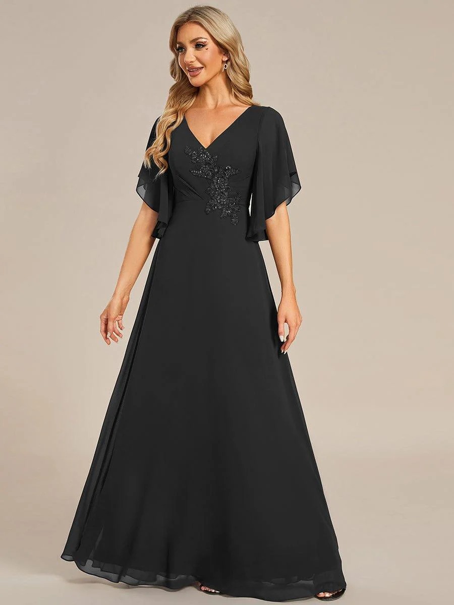 Lorie A graceful chiffon Mother of the Bride dress featuring elegant half sleeves and beautifully placed appliqué detailing on the bodice for a refined and feminine finish. This dress is not currently in stock but is available to order.
