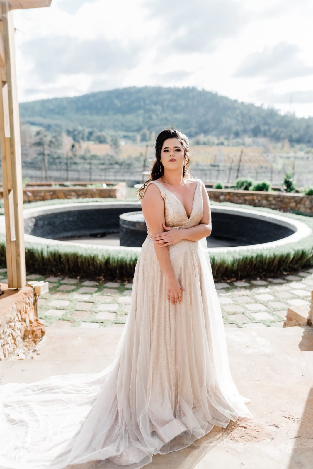 marilee Dazzling Elegance – Shimmer Sequin A-Line Bridal Gown For the bride who loves glamour and versatility, this breathtaking A-line bridal gown is designed to make you sparkle with every step. ✨ Design Highlights: ✔ V-neckline bodice – Flattering and sophisticated, enhancing the décolletage. ✔ Full-flare A-line skirt – Flowing effortlessly for a regal and ethereal look. ✔ Low V-back – A striking yet elegant feature for modern allure. ✔ Shimmering sequin fabric – Catching the light beautifully for a radiant bridal glow. ✔ Detachable shimmer glitter tulle overlay – Adds extra drama and sparkle, giving you two looks in one. 💫 Customization Options: ✅ Tailored to your exact measurements for a flawless fit. ✅ Available in your choice of colour. ✅ Choose between a long or short train to suit your vision. ✅ Option for short or long sleeves for added versatility. ✅ Personalize it with or without a slit for a sleek or classic touch. 📞 Custom orders available! 📧 info@bestersbridal.co.za | 📱 084 268 1354