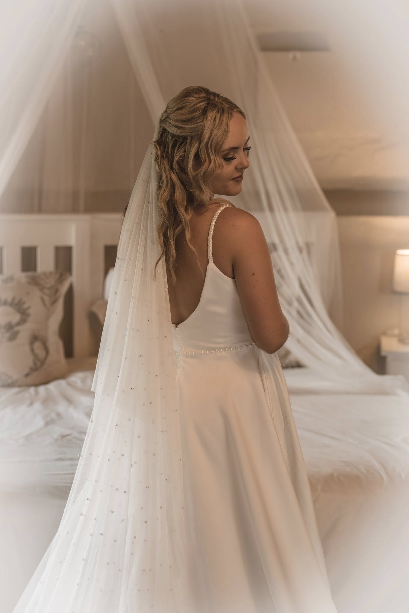 amanda Amanda – Timeless A-Line Bridal Gown with Pearl Elegance For the bride who adores modern simplicity with luxurious detail, the Amanda gown offers a stunning fusion of elegance and grace, crafted in rich winter white Milano stretch for structure, comfort, and refined sophistication. ✨ Design Highlights: ✔ Pearl Straps – Delicate and romantic, adding subtle sparkle and charm. ✔ V-Neckline Bodice – Flattering and timeless, paired with a beautifully contoured fit. ✔ Low V-Back with Pearl Button Closure – A classic detail with modern allure. ✔ Full-Flare A-Line Skirt – Flows effortlessly with side pockets for a modern touch. ✔ Long Train – Adds soft drama and a regal finish as you walk down the aisle. ✔ Pearl Waist Belt – Accentuates the waist with elegance and definition. 💫 Customization Options: ✅ Expert alterations for a flawless, made-for-you fit ✅ Detachable train or modified length available on request ✅ Add custom embellishments or neckline adjustments ✅ Optional pearl sleeve or strap variation 👑 Amanda is the gown for the bride who dreams of understated luxury with polished pearl detail. A perfect balance of minimalism and glamour. 👑 📞 Custom fitting & appointments welcome! 📧 info@bestersbridal.co.za | 📱 084 268 1354