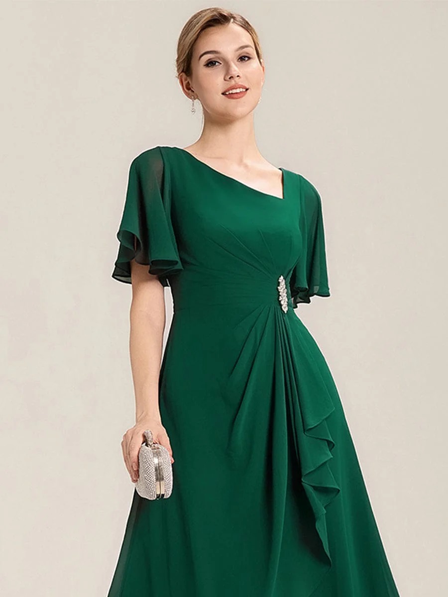 Lilou A beautifully pleated chiffon midi dress designed for plus-size elegance, featuring soft ruffle sleeves and a flattering flowy silhouette — perfect for any special celebration. This dress is not currently in stock but is available to order.