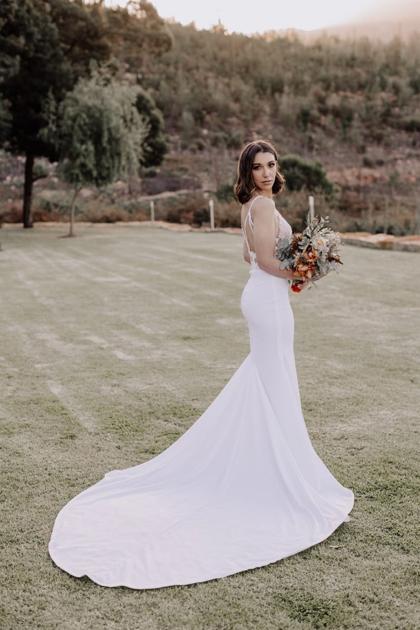 gabriela Elegant Mermaid Crepe & Lace Wedding Gown A breathtaking fusion of modern sophistication and timeless romance, this mermaid bridal gown is designed to accentuate your curves with elegance and grace. ✨ Design Highlights: ✔ Sheer beaded lace bodice – Intricately adorned for a touch of luxury. ✔ Spaghetti straps – Delicate and feminine for a sleek, refined look. ✔ Beaded strap back bodice – Adds a captivating and glamorous detail. ✔ Figure-hugging mermaid skirt – Flattering and sculpted for a showstopping silhouette. ✔ Crepe fabric – Smooth and sophisticated for an effortless bridal statement. 💫 Customization Options: ✅ Made to measure for the perfect fit. ✅ Available in your preferred colour. ✅ Choose a long or short train to match your vision. ✅ Option for short or long sleeves for added versatility. ✅ Personalize it with or without a slit for a modern or classic touch. 👑 For the bride who wants to make a lasting impression with elegance and style. 👑 📞 Custom orders available! 📧 info@bestersbridal.co.za | 📱 084 268 1354