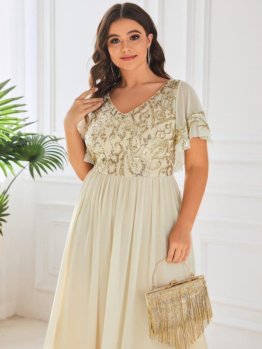 Hazel A sophisticated Mother of the Bride dress featuring a sparkling sequin V-neck bodice, soft short sleeves, and a smooth, flowing skirt for timeless elegance. This dress is not currently in stock but is available to order.