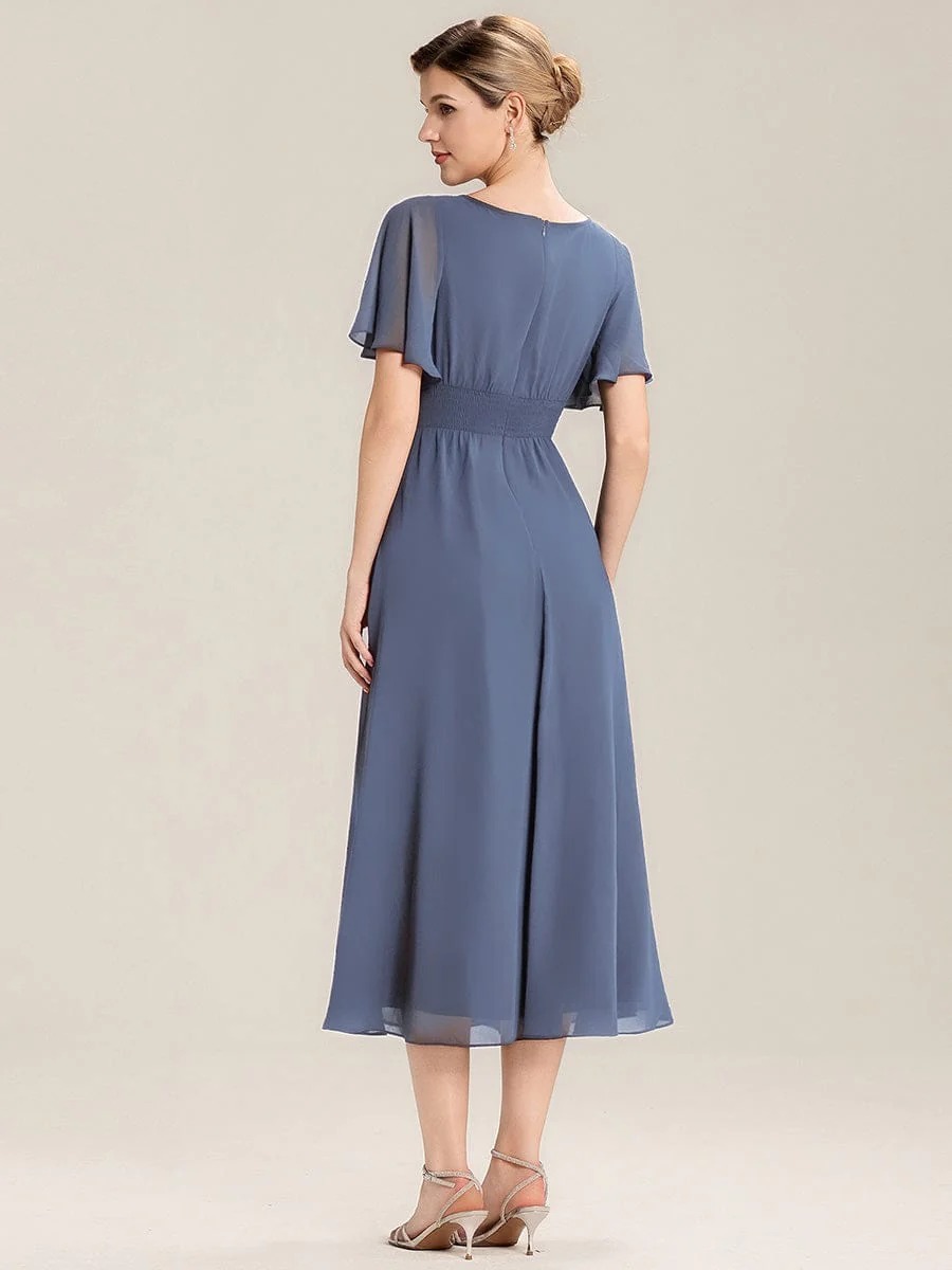 Lilou A beautifully pleated chiffon midi dress designed for plus-size elegance, featuring soft ruffle sleeves and a flattering flowy silhouette — perfect for any special celebration. This dress is not currently in stock but is available to order.
